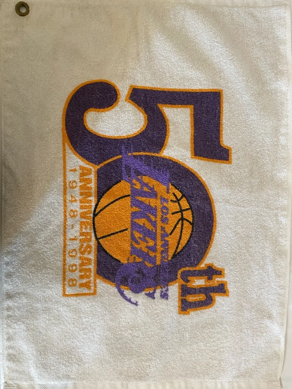 Los Angeles Lakers 50th anniversary towel with team's commemorative logo.